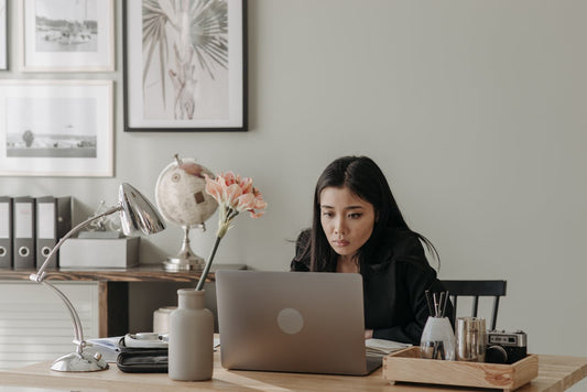 Modern home office setup with laptop stand, keyboard, and LED lights