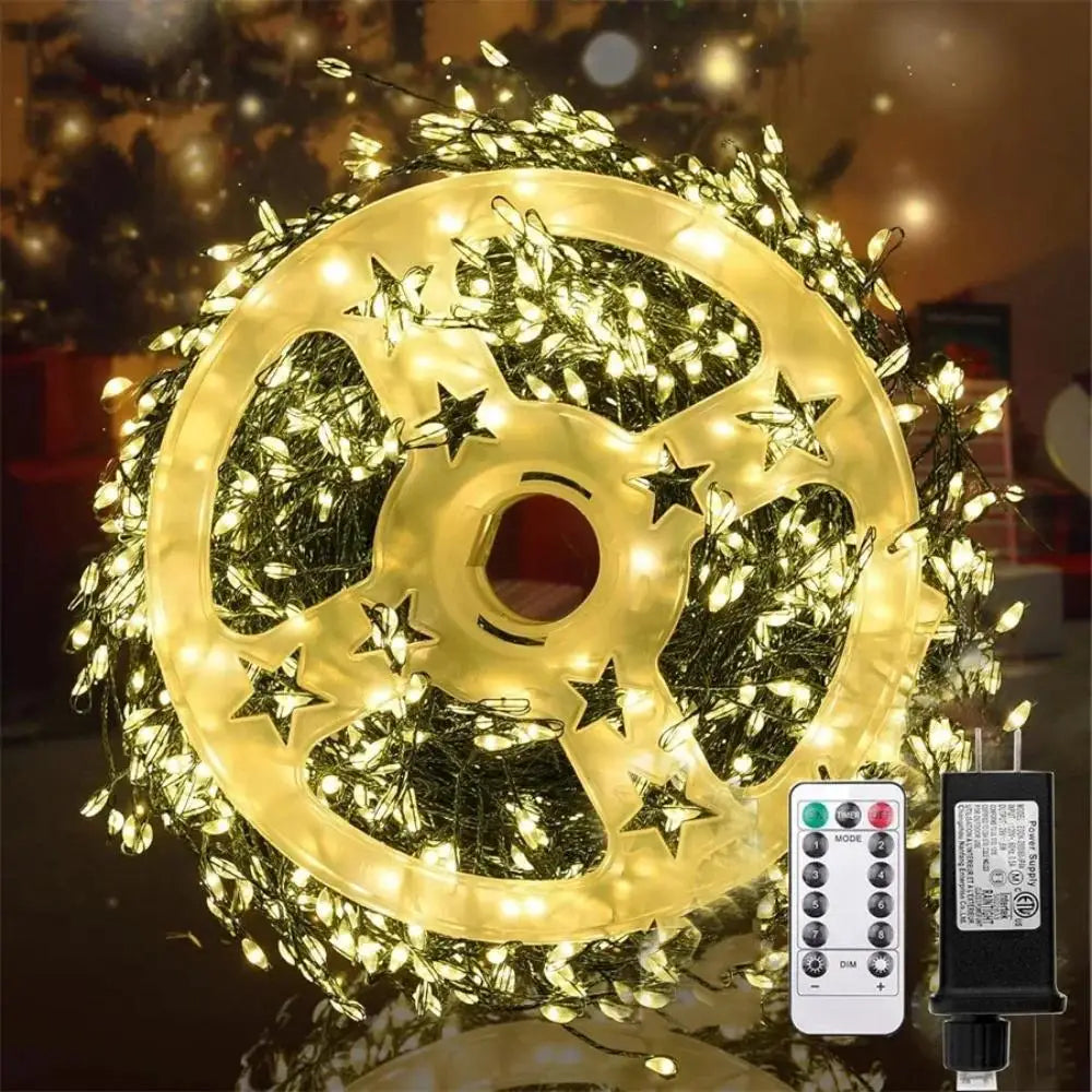 Decorative light wheel with string lights and remote control on a reflective surface.