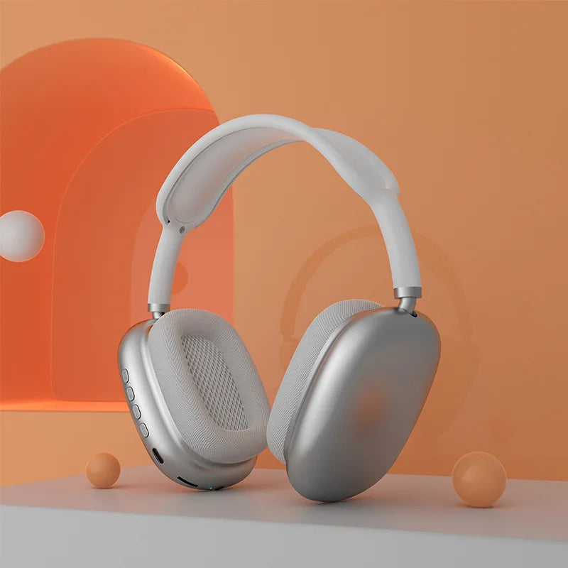 Silver headphones on an orange and beige gradient background